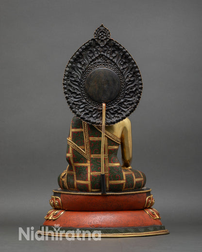 back view of shakyamuni buddha statue with carved torana and lotus base detailing
