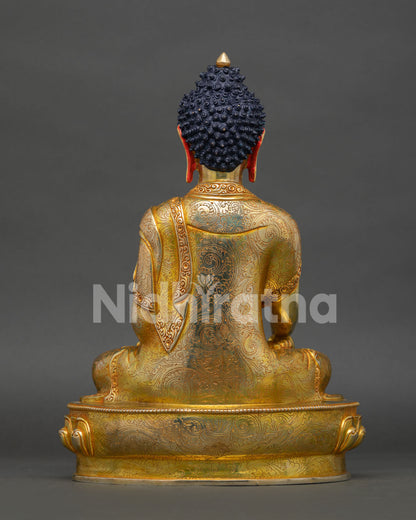 back view of shakyamuni buddha statue with detailed robes and engraved lotus base