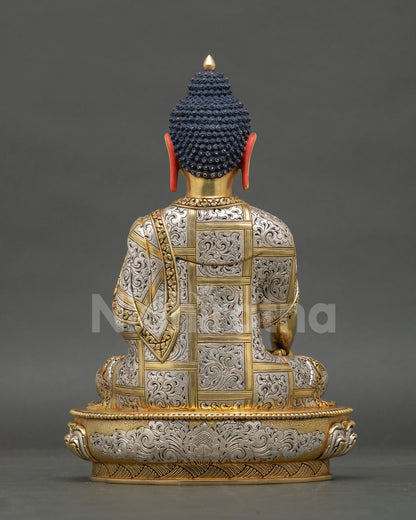 Back view of Shakyamuni Buddha statue with engraved robe and lotus base