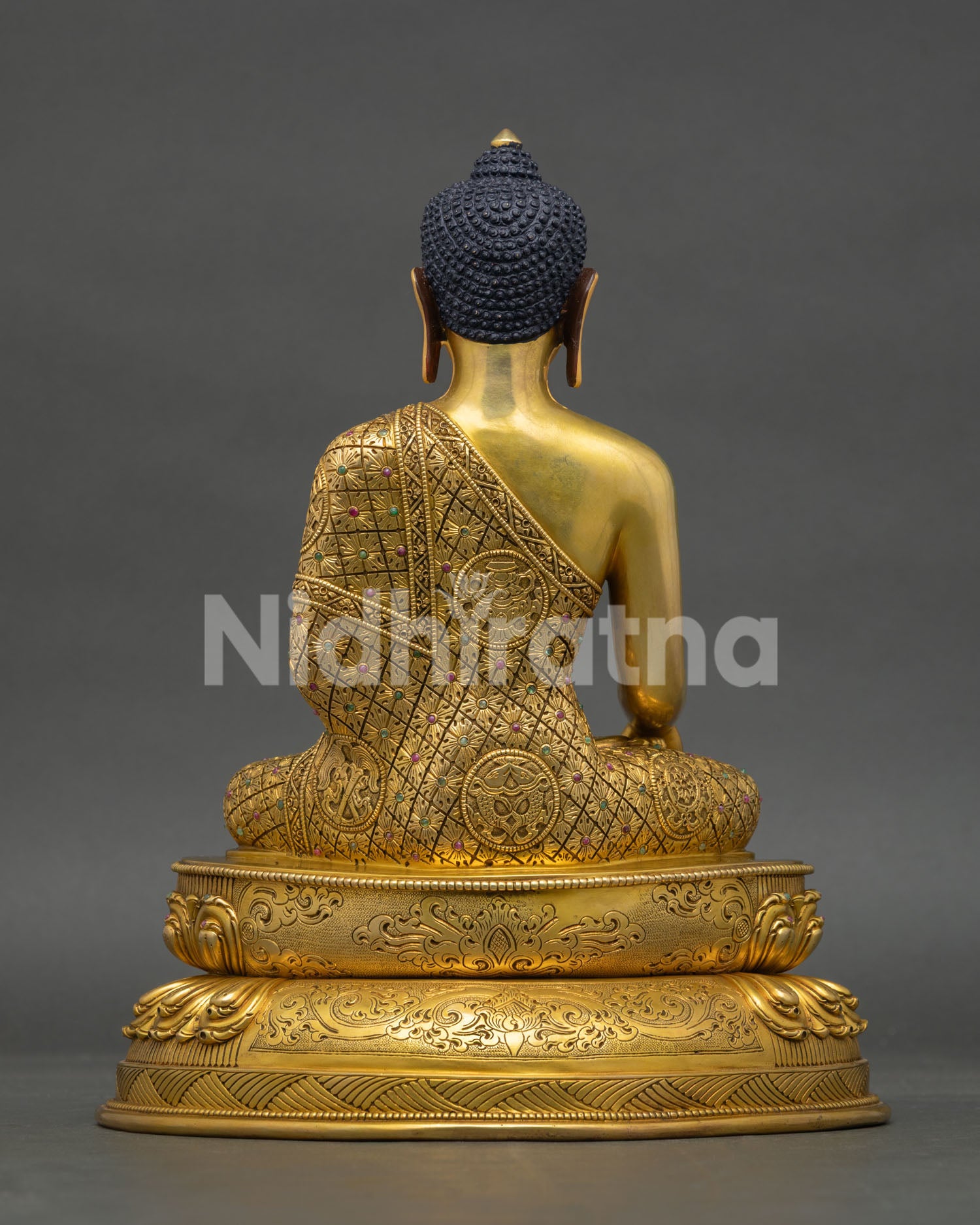 Back view of Shakyamuni Buddha statue with engraved robe patterns and handcrafted copper details from Nepal