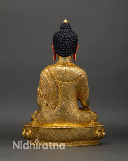 Back view of Shakyamuni Buddha statue with lotus pedestal and intricate robe patterns