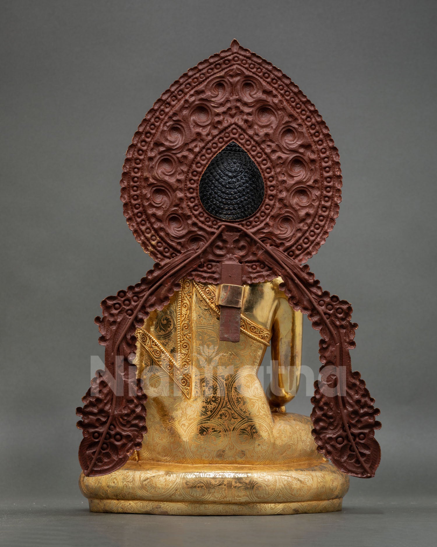 back view of Shakyamuni Buddha statue with ornate floral halo craftsmanship