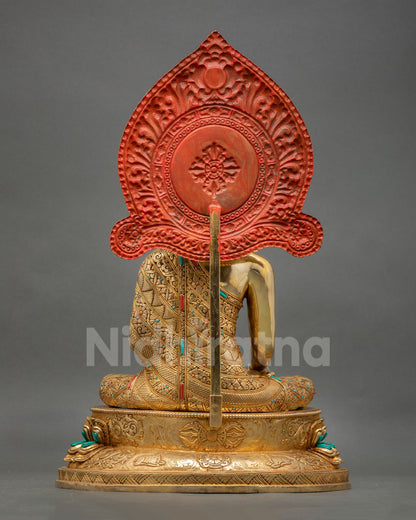 back view of shakyamuni buddha statue with vajra deer and dharma wheel carving