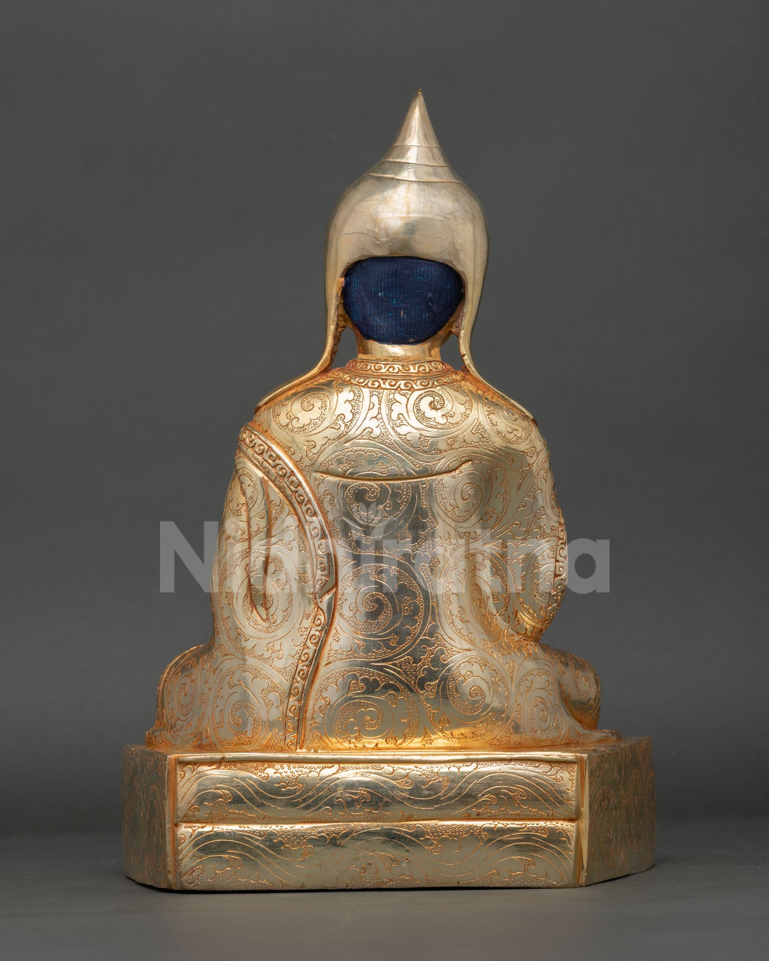 Back view of Shantarakshita statue showcasing detailed craftsmanship and gilding
