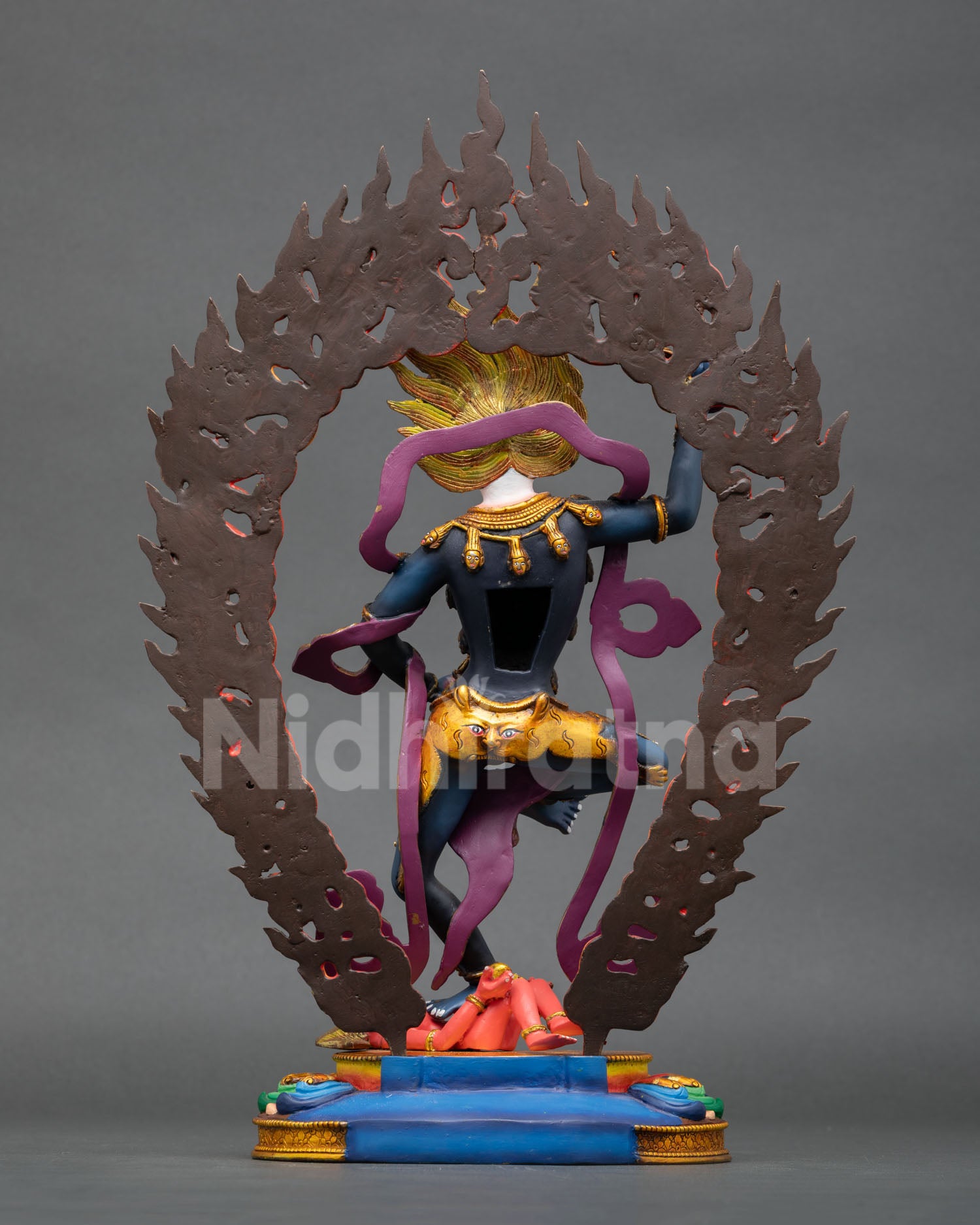 back view of simhamukha copper statue with flaming halo and tantric ornaments