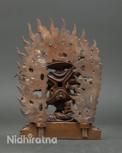 Back view of Six-Armed Mahakala statue with flaming halo, standing on carved lotus pedestal, handmade Nepal Buddhist Dharma protector art.