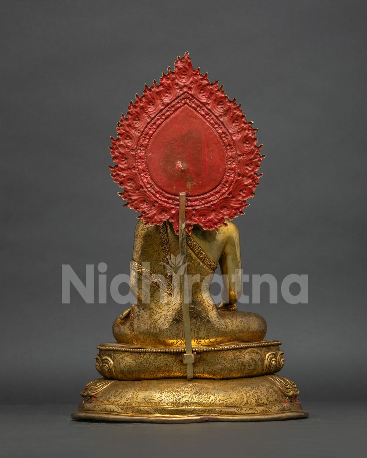 Back view of solid copper Buddha statue, showcasing carved halo and robe craftsmanship
