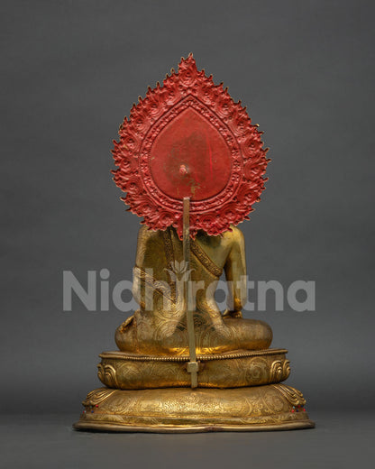 Back view of solid copper Buddha statue, showcasing carved halo and robe craftsmanship