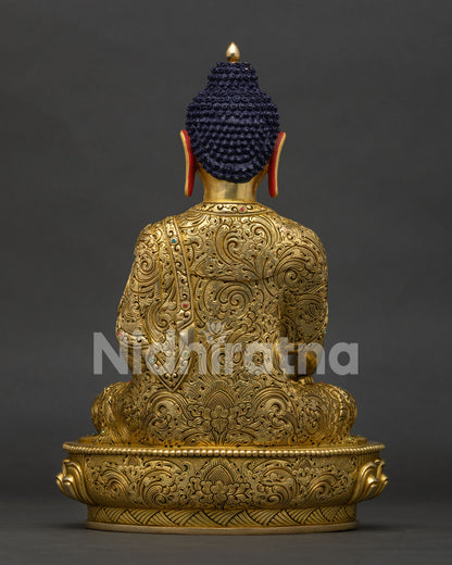Back view of solid copper Shakyamuni Buddha statue showing detailed hand-chased robe