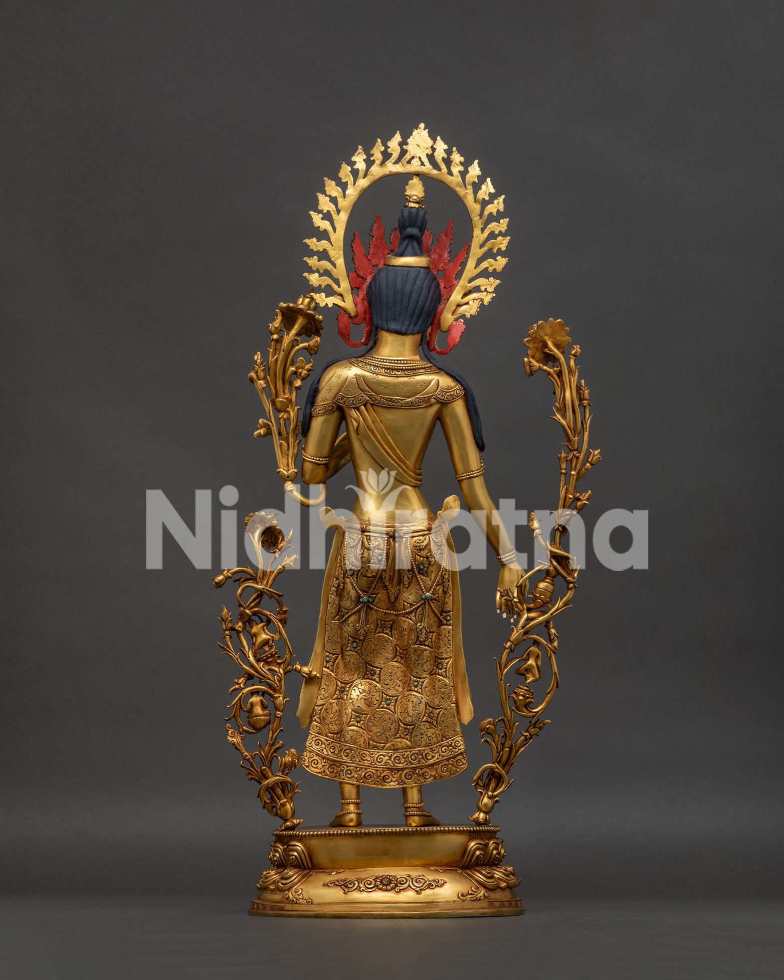 back view of standing green tara statue revealing intricate copper craftsmanship and halo