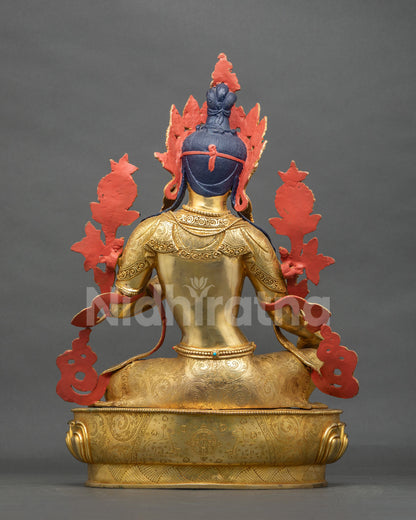 Back view of the Arya Tara statue showing hand-chased robe engravings and an engraved lotus pedestal