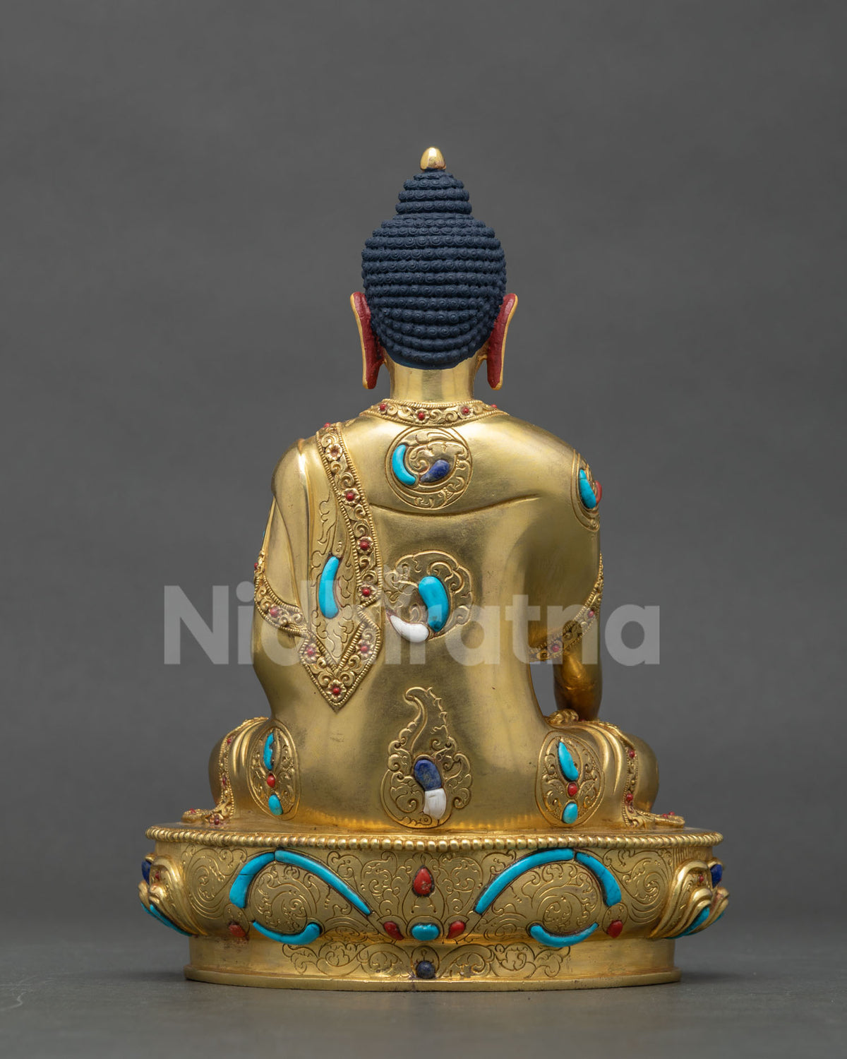 Back view of the handmade Nepalese copper Shakyamuni Buddha statue displaying artisan metalwork.