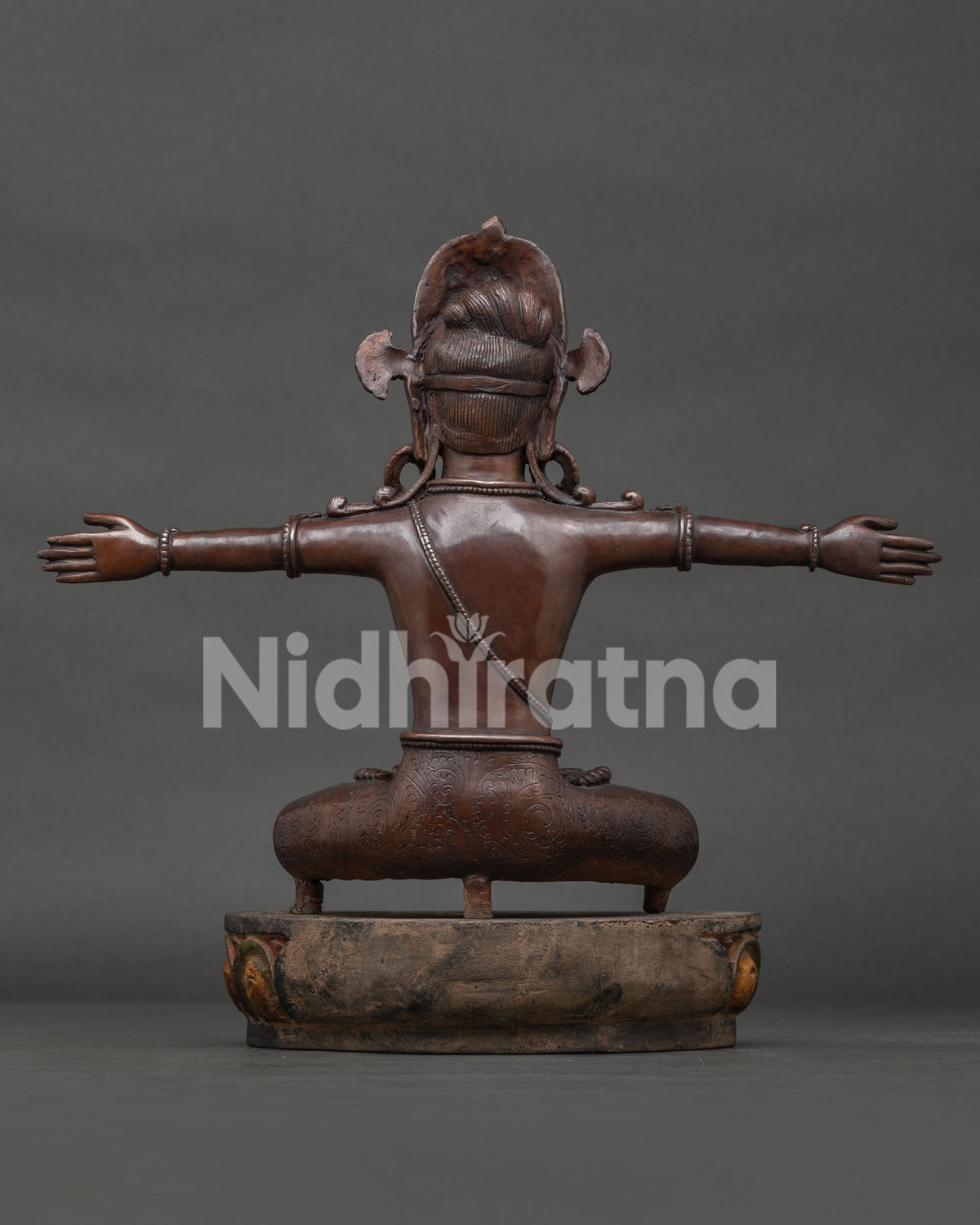 Back view of the oxidized copper Bound Lord Indra statue, displaying masterful Nepalese metal carving.