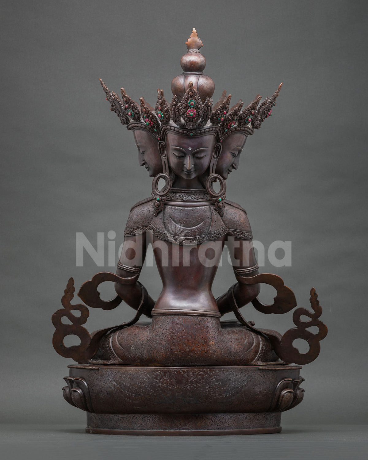Back view of the Sarvavid Vairocana statue showing hand-chased engravings on oxidized copper