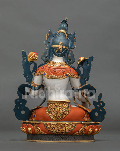 back view of tibetan buddhist white tara statue with gold gilded scrollwork and lotus base