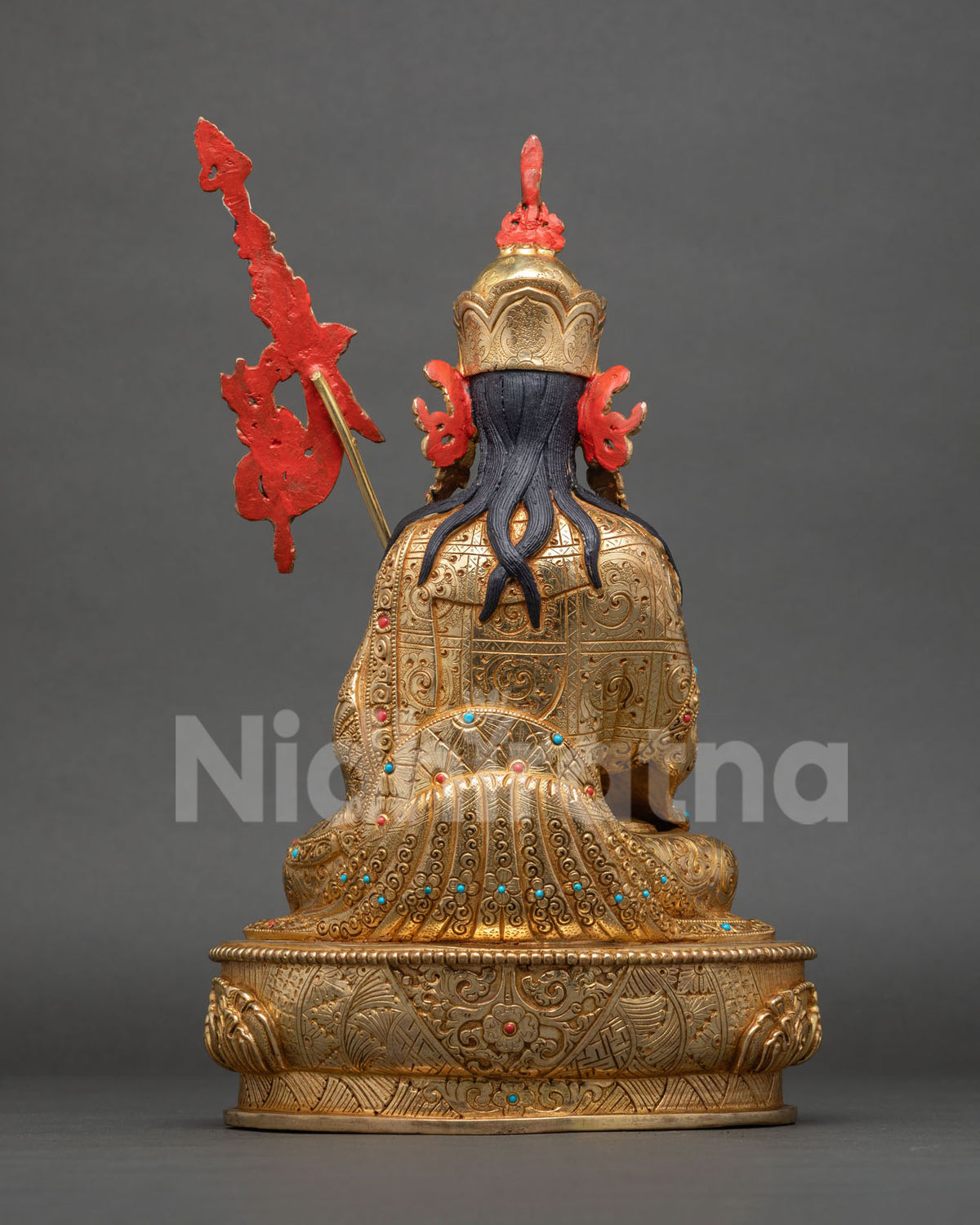 Back view of Tsokye Dorje statue showing engraved gold-gilded robe, hair detail and lotus base