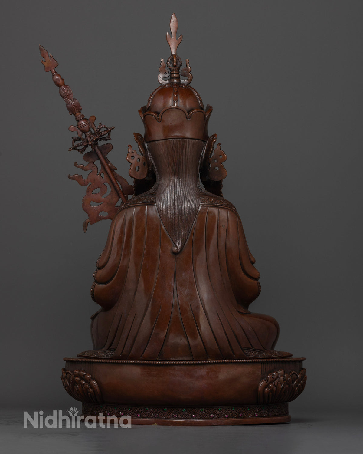 Back view of Tsokye Dorje statue with hand-carved floral details and oxidized copper finish