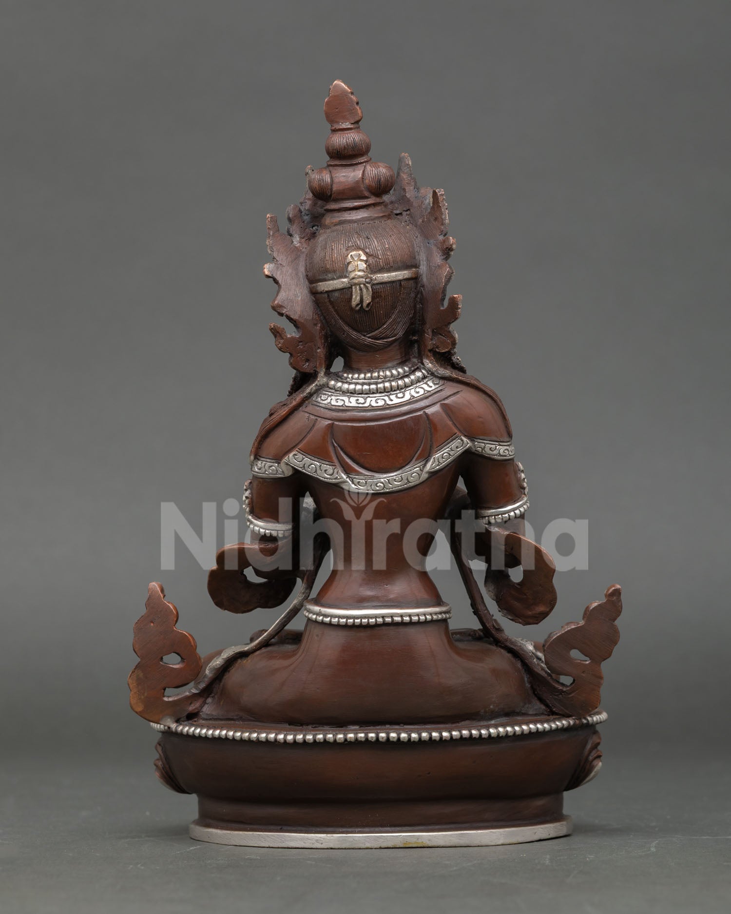 Back view of Vajradhara Buddhist statue highlighting oxidized copper finish flowing robes and Nepalese artisan metalwork