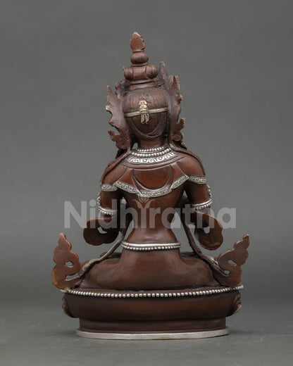 Back view of Vajradhara Buddhist statue highlighting oxidized copper finish flowing robes and Nepalese artisan metalwork