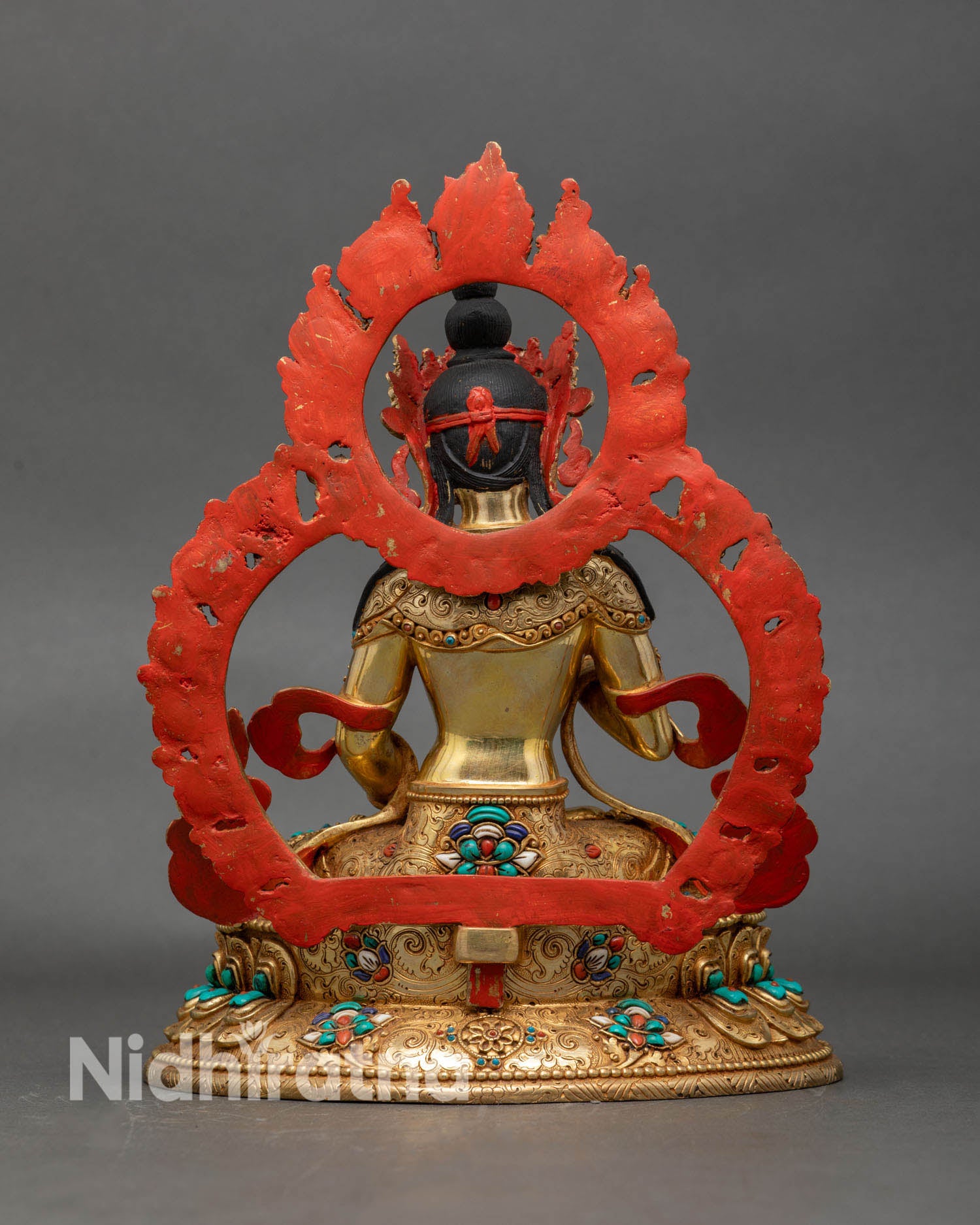 Back view of Vajrasattva statue, gold-gilded lotus pedestal, sacred Tibetan Mahayana deity.