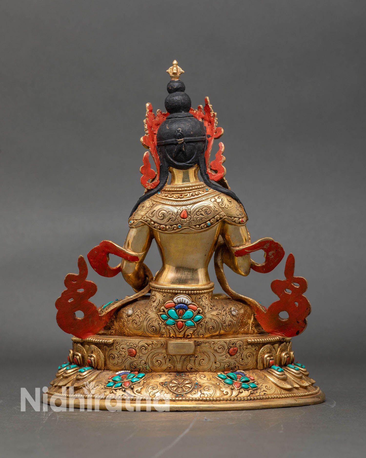 Back view of Vajrasattva statue, gold-gilded lotus seat and sacred deity decoration