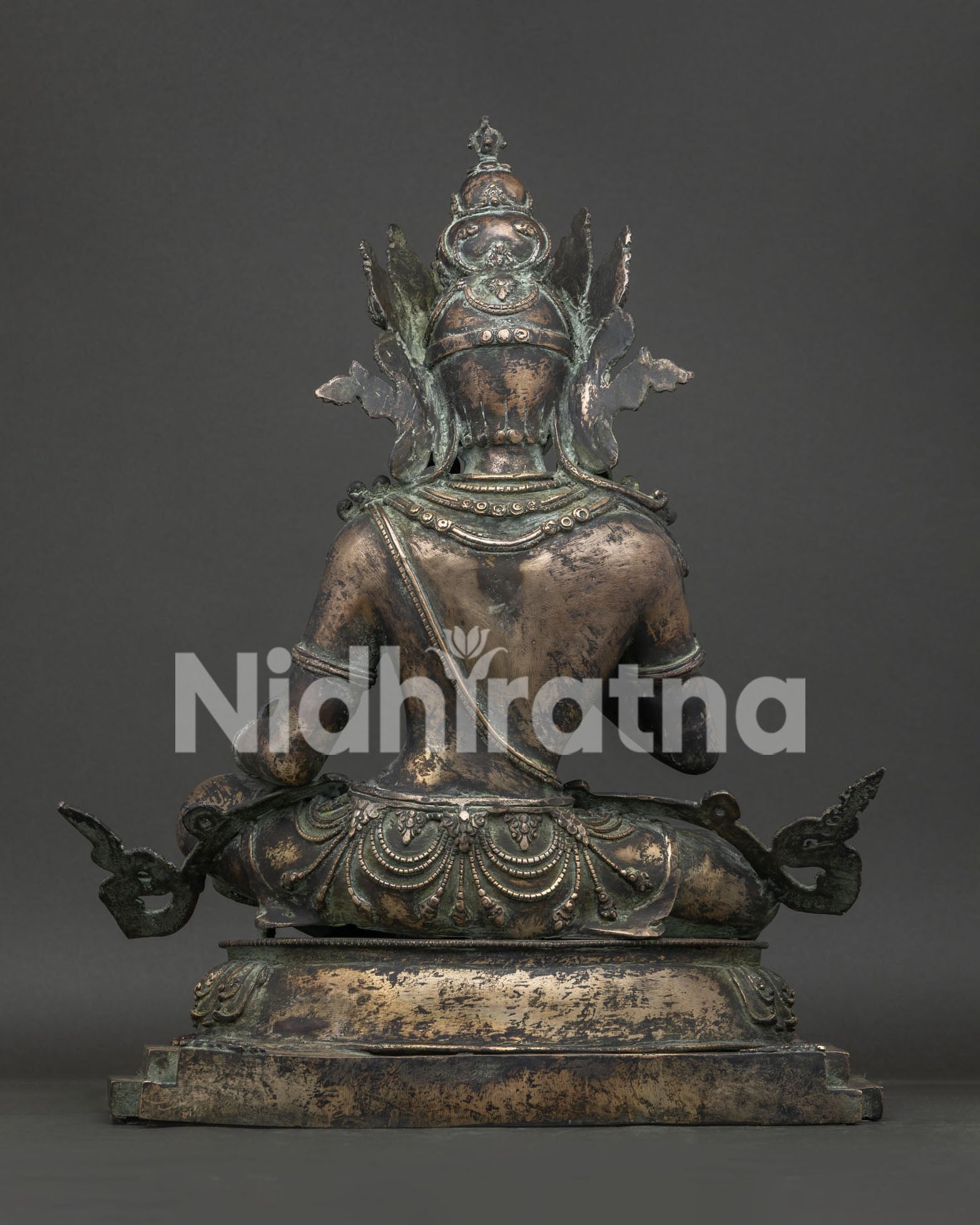 Back view of Vajrasattva statue showing bronze casting and lotus pedestal base