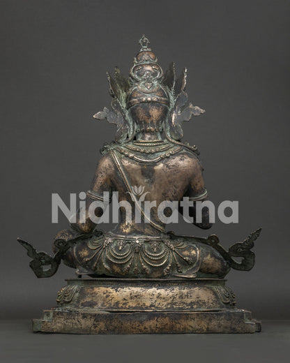 Back view of Vajrasattva statue showing bronze casting and lotus pedestal base
