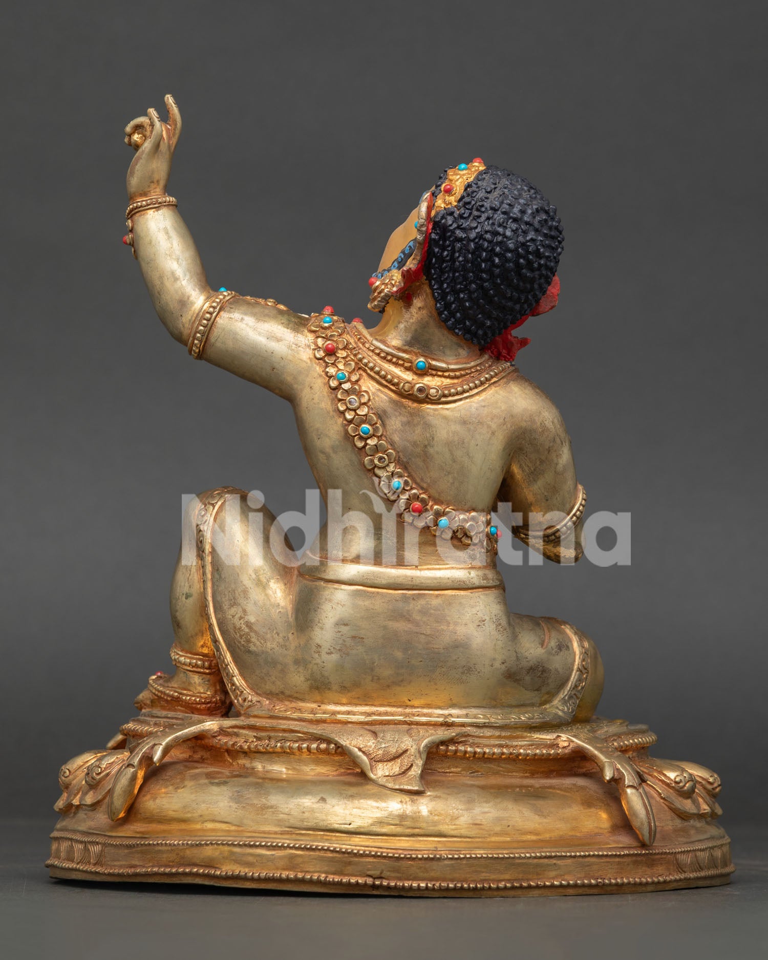 Back view of Virupa Statue featuring detailed robe carvings, lotus throne, and traditional Himalayan metalwork