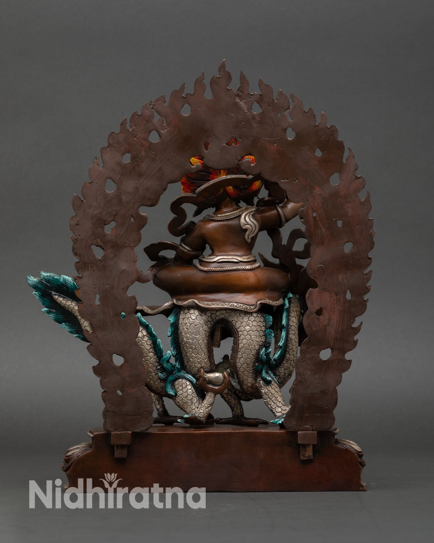 Back view of White Dzambhala statue with silver-plated robe and intricate Newari craftsmanship from Nepal