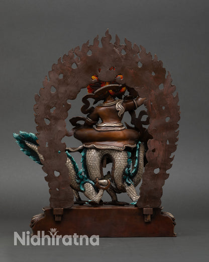 Back view of White Dzambhala statue with silver-plated robe and intricate Newari craftsmanship from Nepal