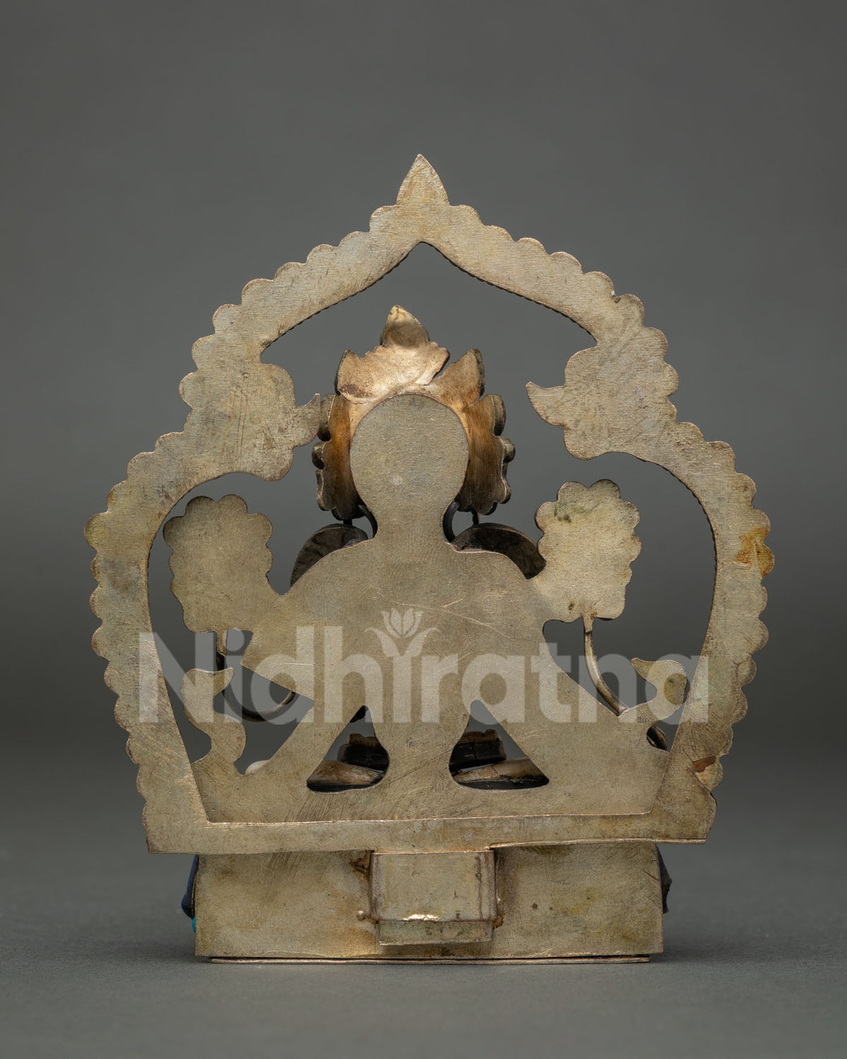 Back view of White Tara copper statue showing handcrafted halo and pedestal from Nepal