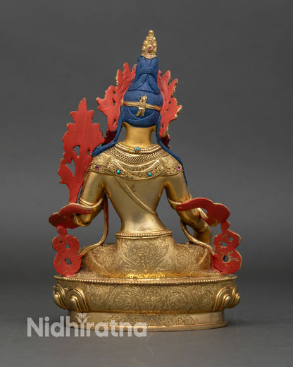 Back view of White Tara meditation statue showing detailed copper and gold workmanship