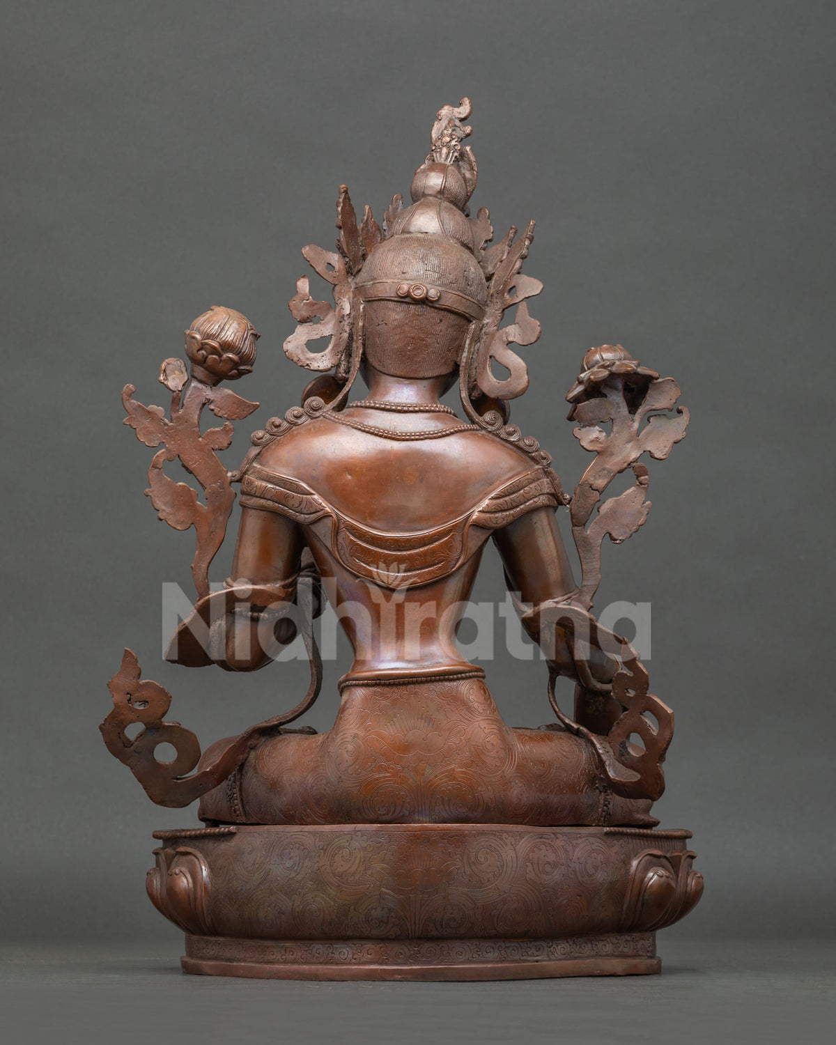 Back view of White Tara statue handcrafted in copper with detailed robes lotus pedestal and patina.