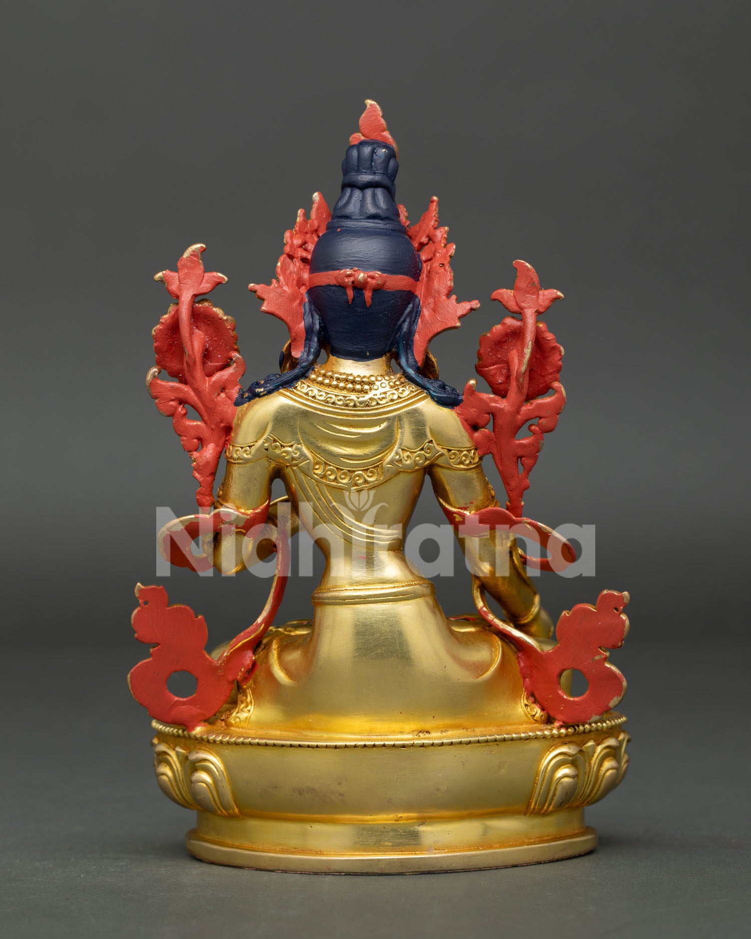 Back view of White Tara statue revealing intricate Buddhist artwork and handcrafted Nepalese metal detailing