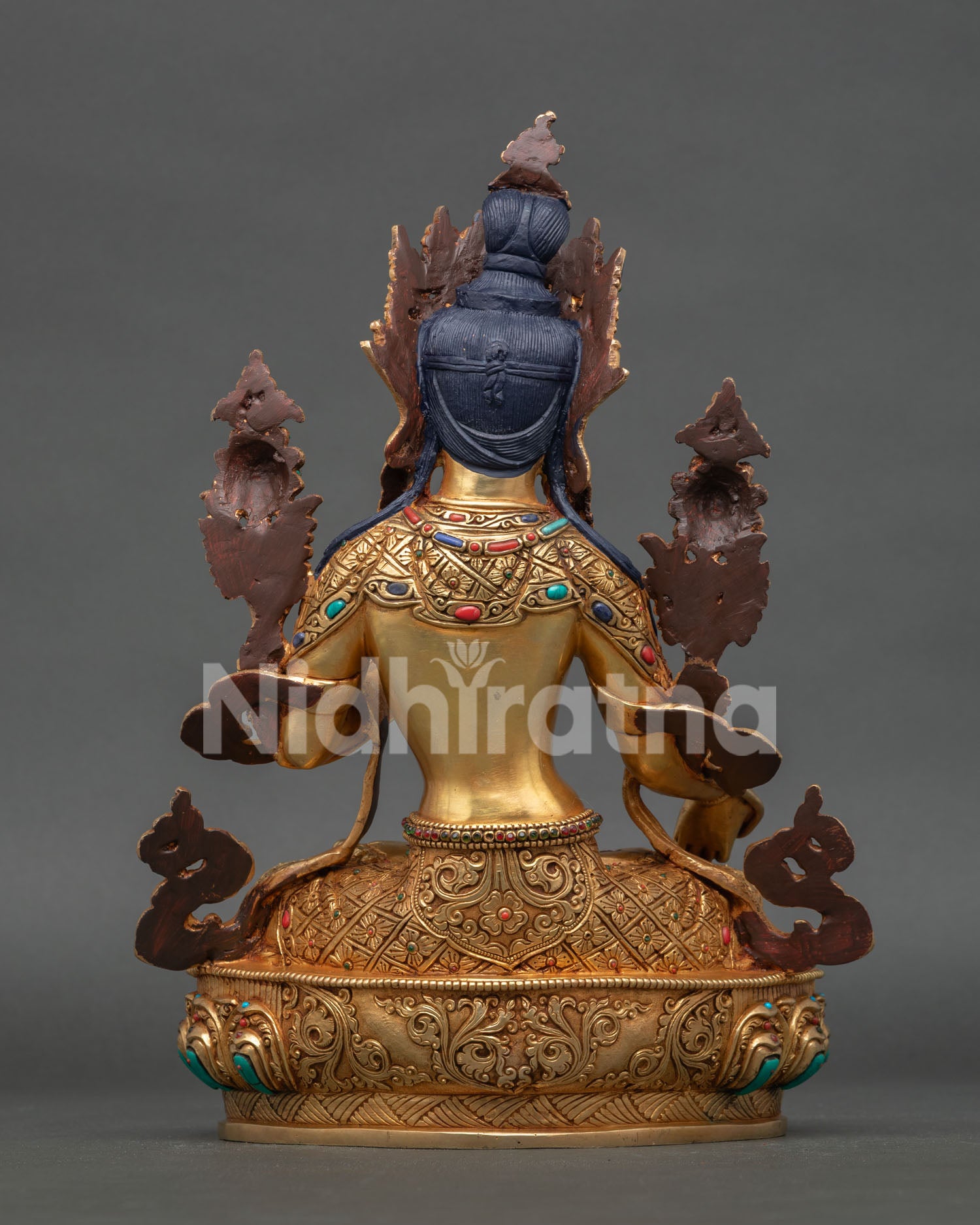 back view of white tara statue showing detailed robe patterns and traditional buddhist artistry