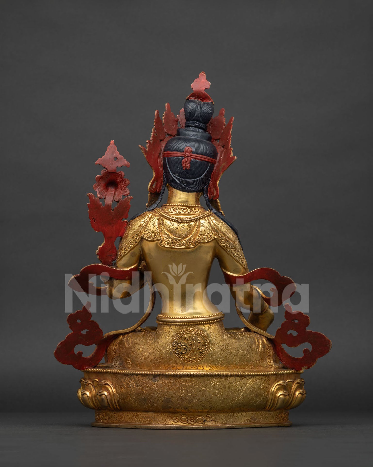 Back view of White Tara statue showing lotus throne and robe detail