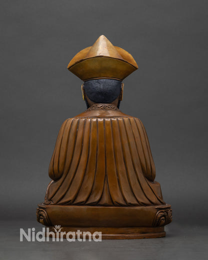 Back view of zhabdrung rinpoche statue, highlighting sculptural details and traditional iconography