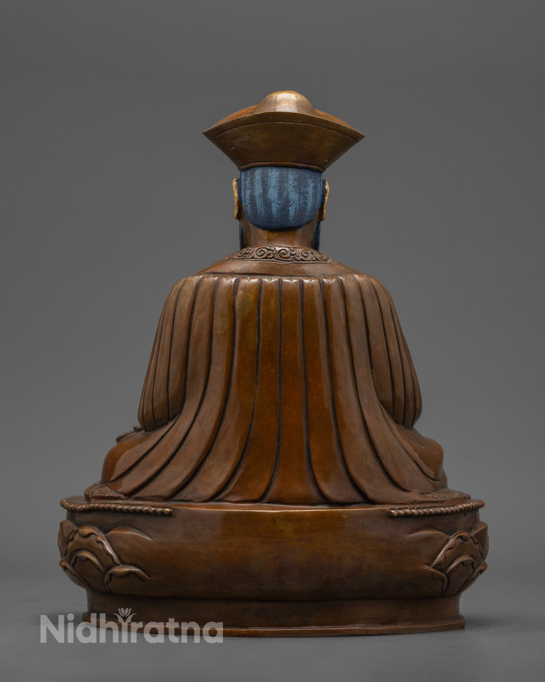 back view of zhabdrung rinpoche statue showing lotus throne and finely carved copper details