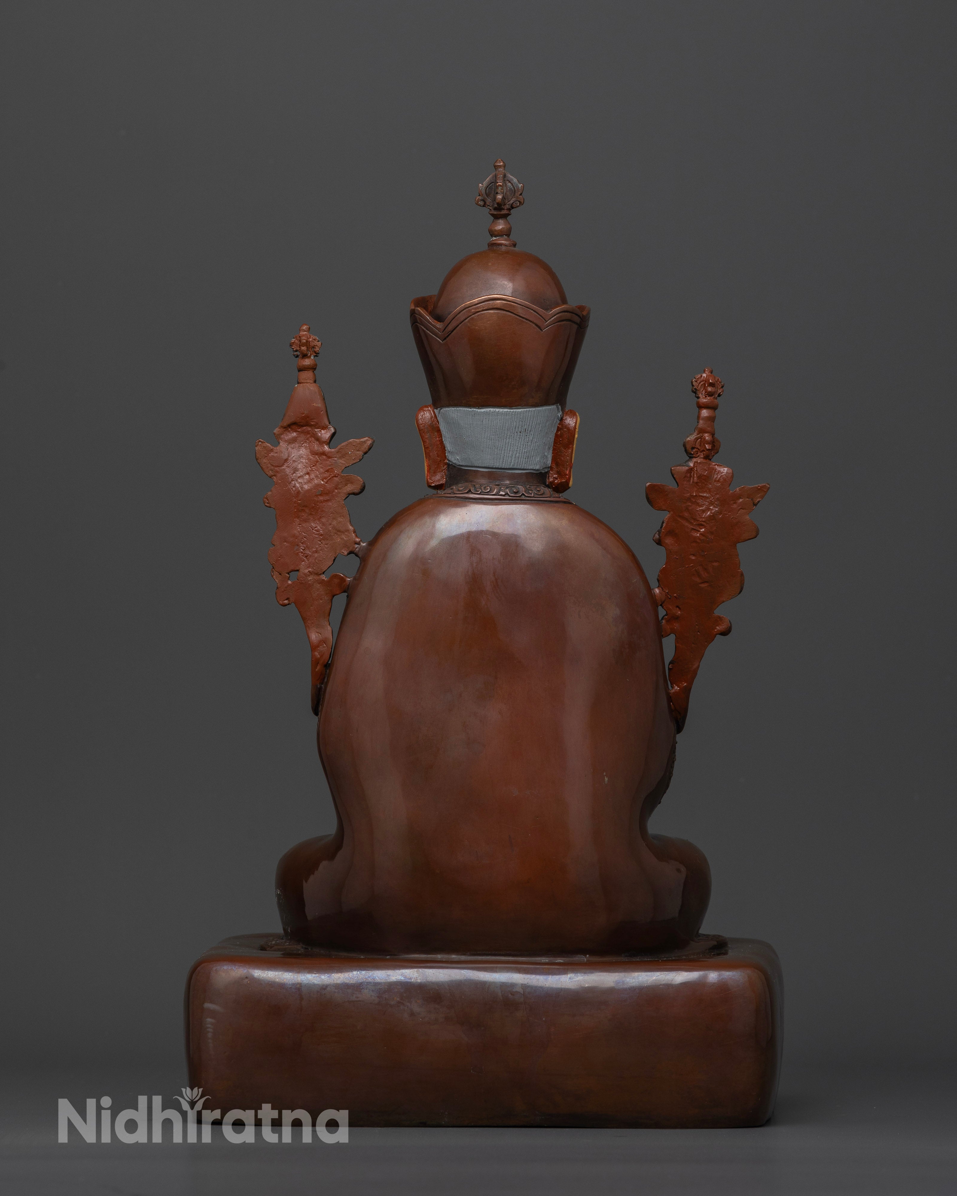 Back view of Zhabdrung statue with hollow chamber and carved base details