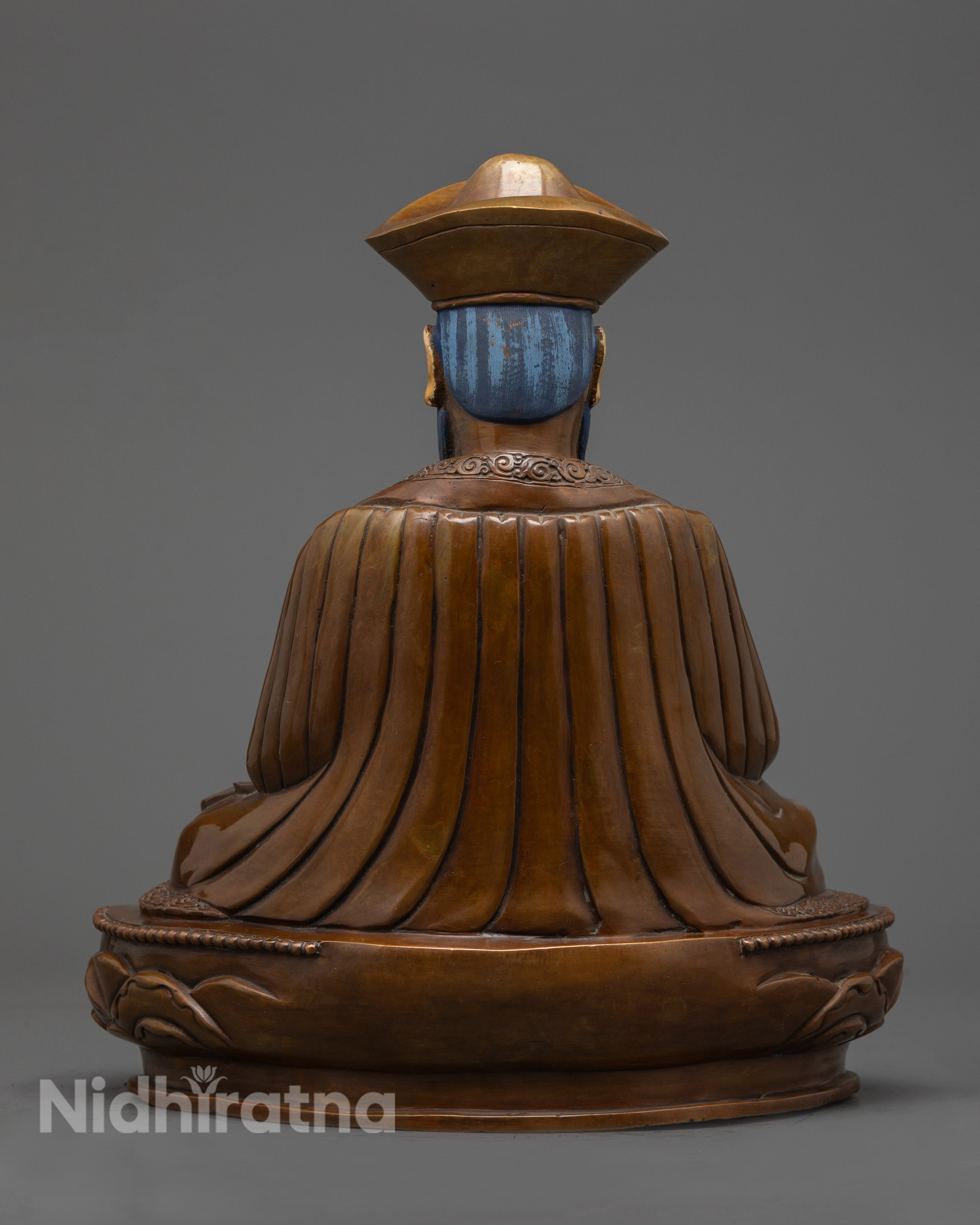 back view of zhabdrung statue with hollow chamber lotus base and carved patterns