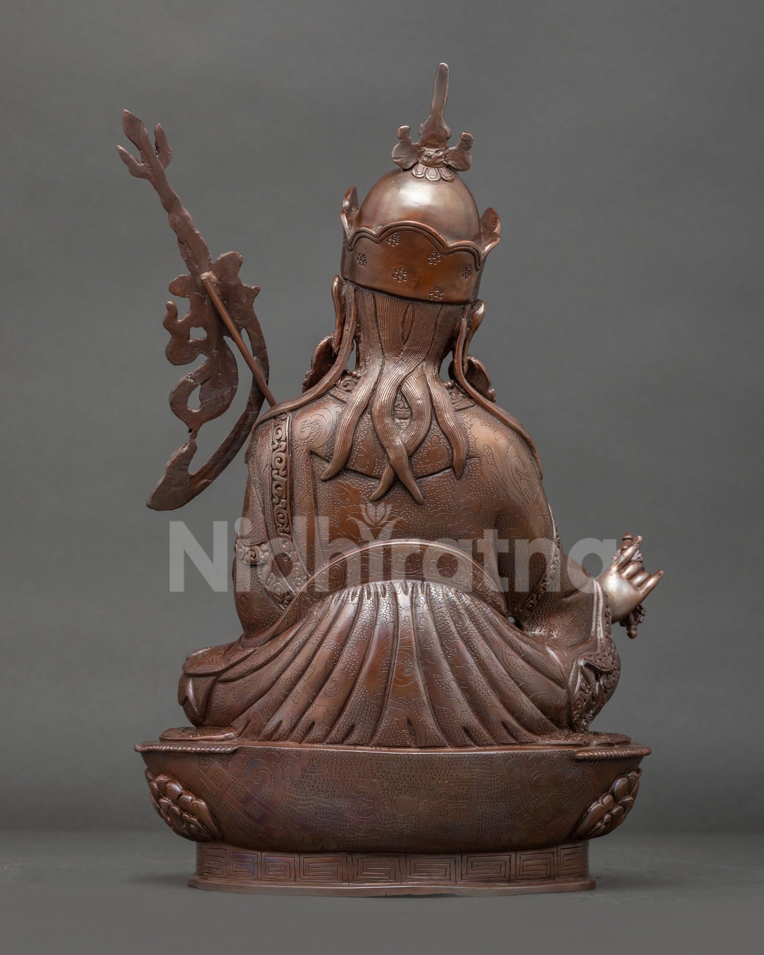 Back view of oxidized copper Guru Rinpoche Buddhist statue for altar meditation shrine and spiritual home decor collection