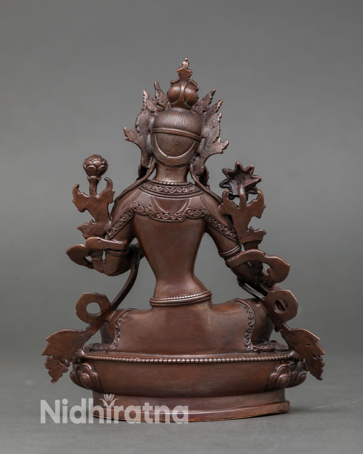 Back view of sacred Green Tara statue Newari craftsmanship from Nepal detailed copper sculpture, lotus base spiritual home altar Buddhist deity statue