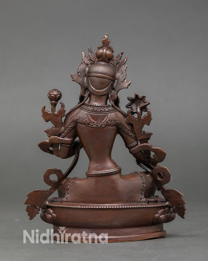 Back view of sacred Green Tara statue Newari craftsmanship from Nepal detailed copper sculpture, lotus base spiritual home altar Buddhist deity statue