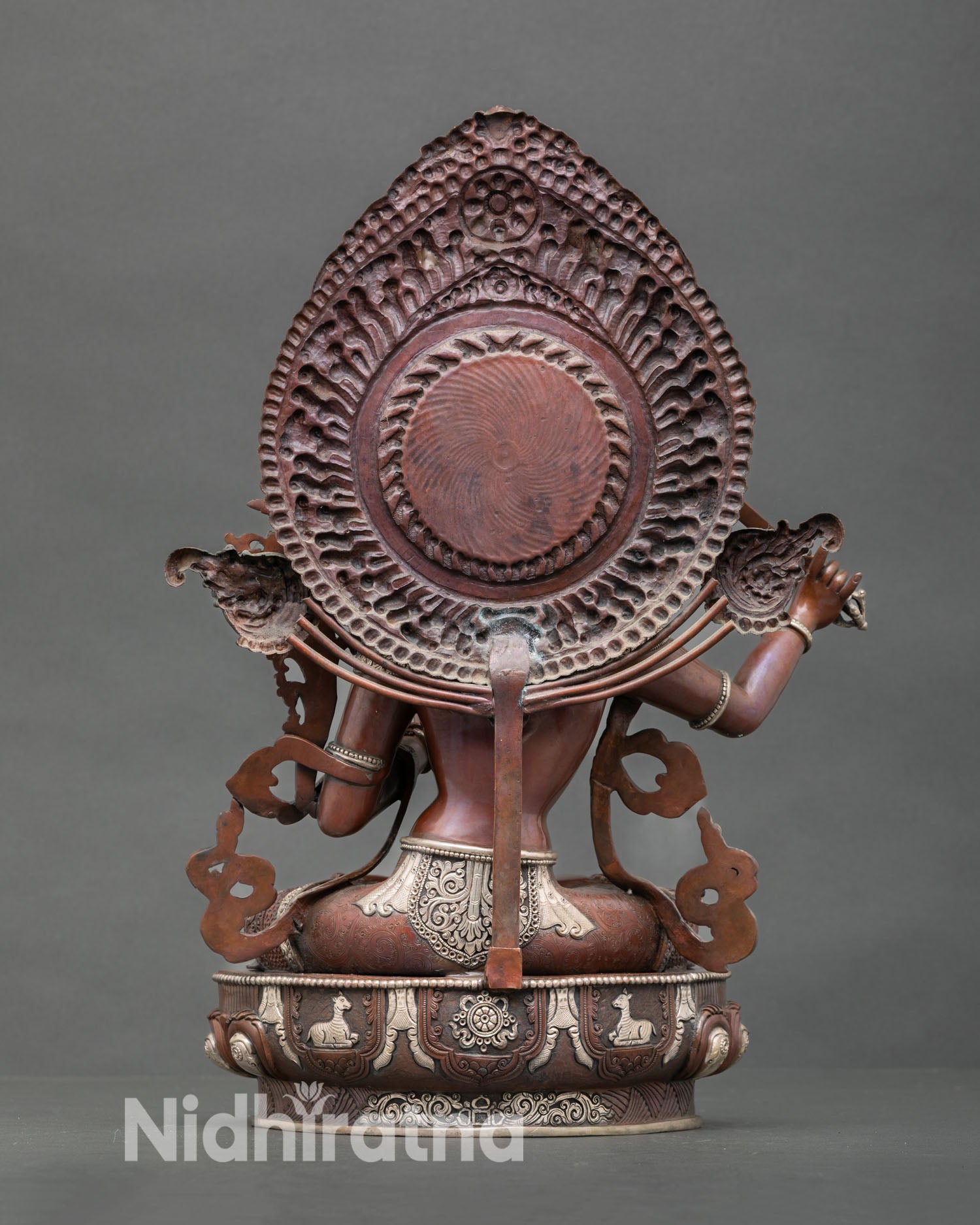 Back view sacred Manjushri Bodhisattva statue handcrafted in Kathmandu Valley showing flowing robes halo detail and silver plated copper finish