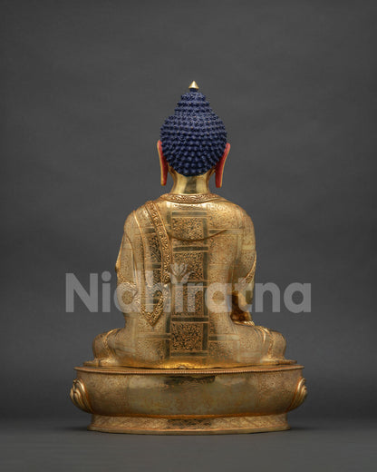 Back view of Shakyamuni Buddha copper statue with intricate gold gilded details and robes