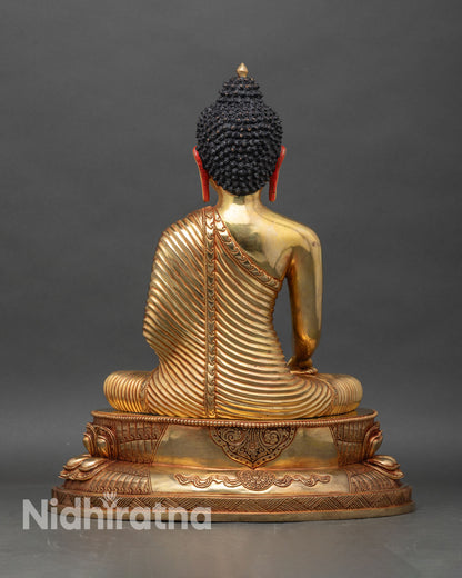Back view of Shakyamuni Buddha statue showing carved lotus pedestal and sacred detailing