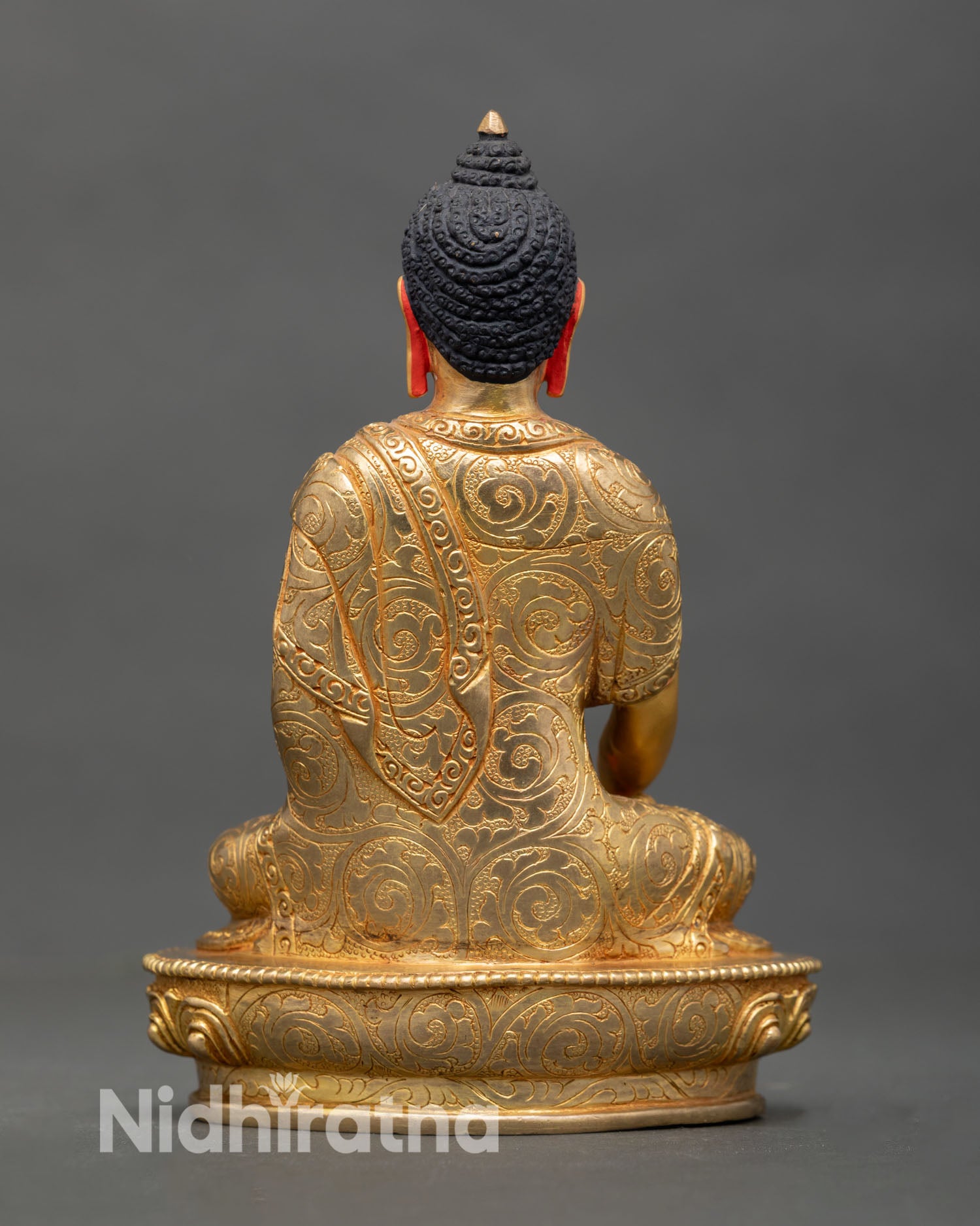 Back view of Shakyamuni Buddha statue handcrafted in copper with gold gilded finish showing flowing monastic robe lotus pedestal and refined Himalayan artistic detailing