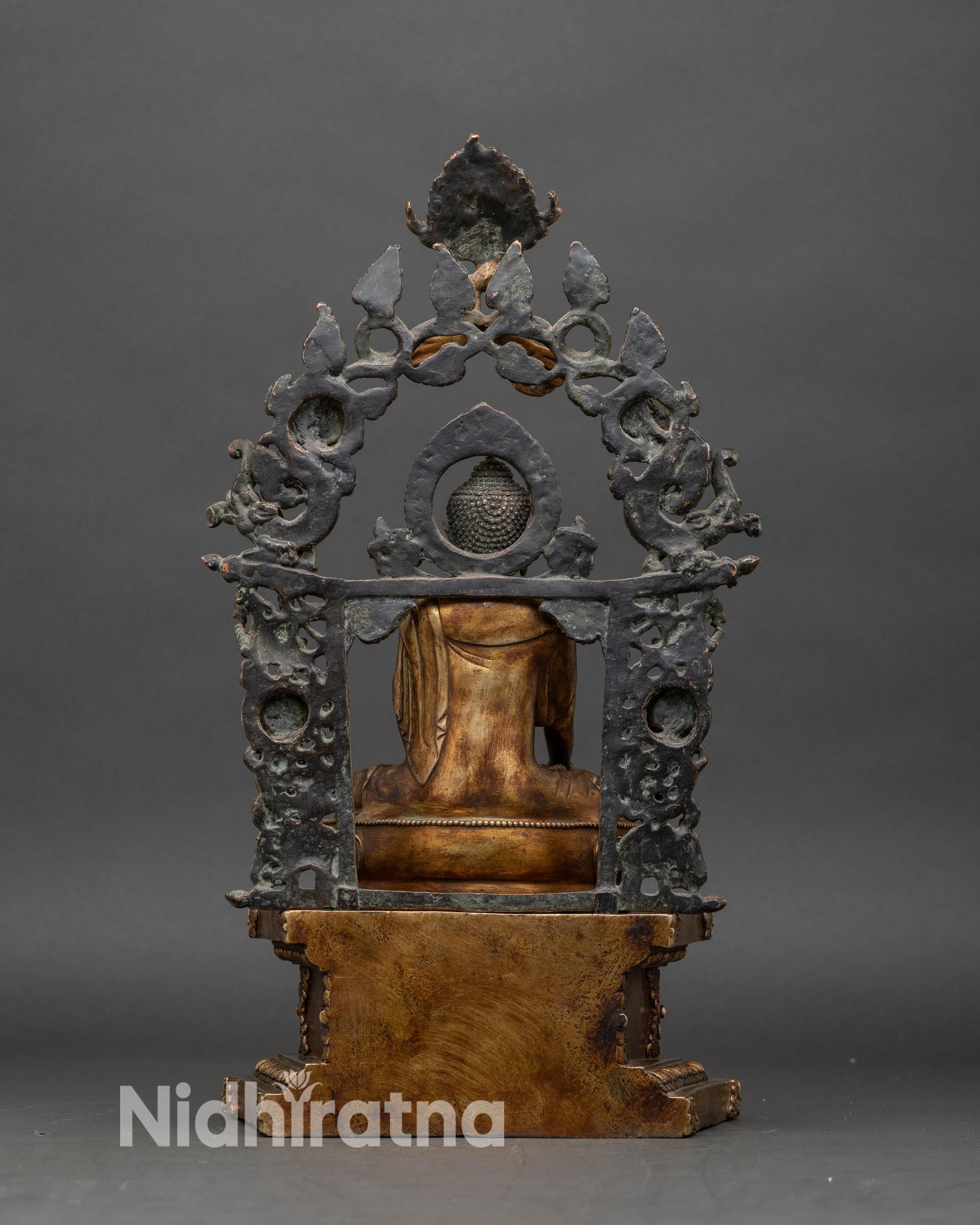 Back view of Shakyamuni Buddha statue, intricate halo and pedestal craftsmanship