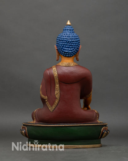 Back view of Shakyamuni Buddha statue, showing intricate lotus pedestal and robe details