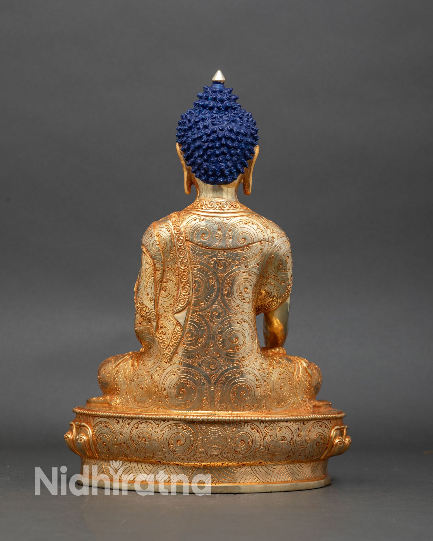 Back view of Shakyamuni Buddha statue intricate robes gold gilded copper Himalayan sculpture